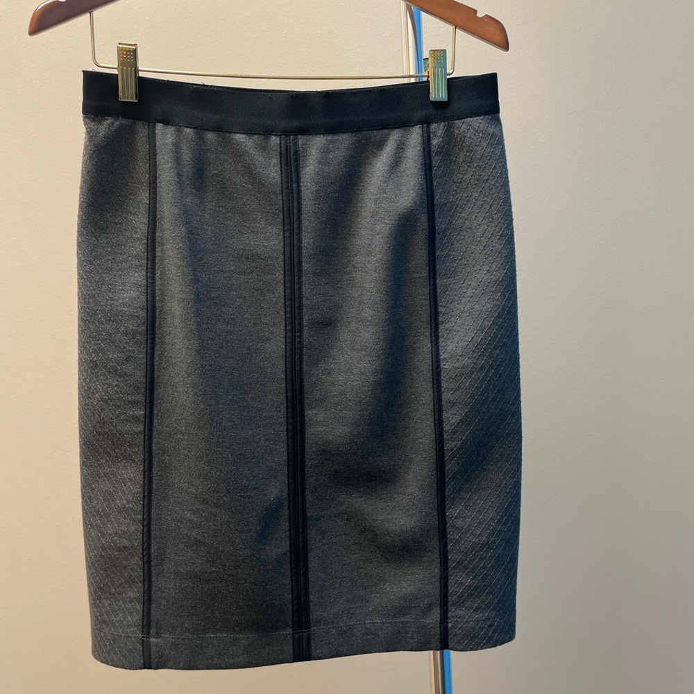 Charcoal gray skirt with details.